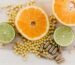 oranges, peas, and limes on a wooden table